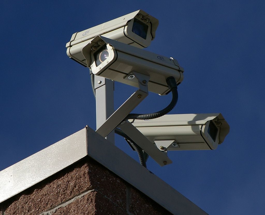 Surveillance cameras on the corner of a building.
